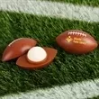 Football-shaped container filled with